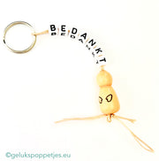 Sleutelhanger bedankt sich mit natürlichen Gelukspoppetjes und Händen