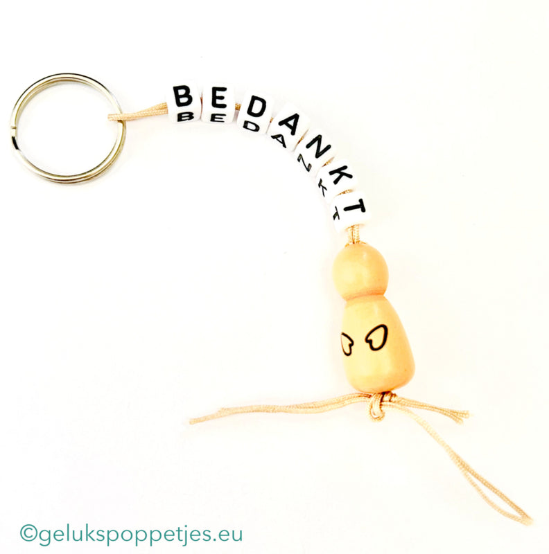 Sleutelhanger bedankt sich mit natürlichen Gelukspoppetjes und Händen