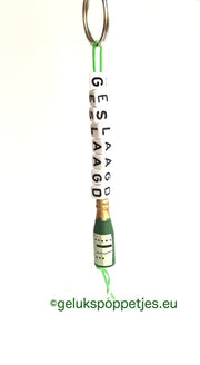 Der Sleutelhanger ist mit Gelukspoppetje Wijnflesje versehen