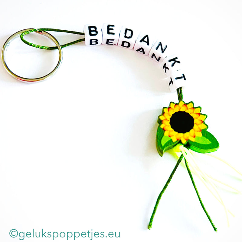 Sleutelhanger bedankt sich mit gelukspoppetje zonnebloem